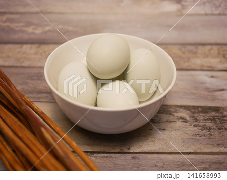 Fresh Duck Eggs in White Bowl on Rustic Wooden Table Background Fresh Duck Eggs in White Bowl on Rustic Wooden Table Background 141658993