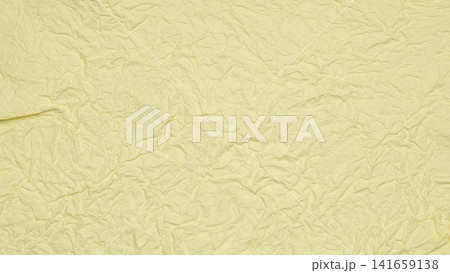 texture of crumpled paper surface of light yellow color 141659138