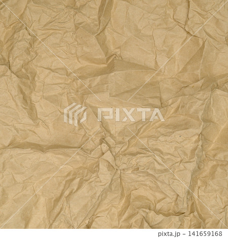 heavily crumpled brown kraft paper sheet with central focal point of dense wrinkles heavily crumpled brown kraft paper sheet with central focal point of dense wrinkles 141659168
