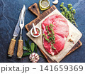 Raw Beef Steak on Wooden Cutting Board with Herbs and Spices 141659369