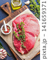 Raw Beef Steak on Wooden Cutting Board with Herbs and Spices 141659371
