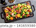Grilled peach and prosciutto salad with green lettuce, balsamic glaze and wine on dark background 141659380