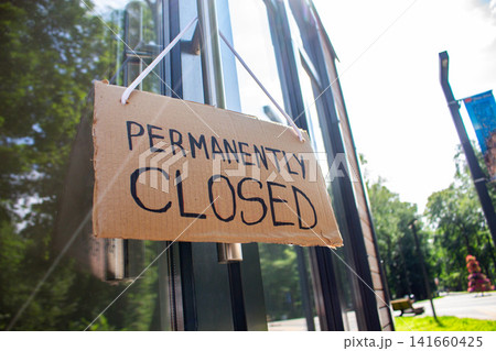 PERMANENTLY CLOSED sign on private shop window. Small local retail business closes because of financial and economic crisis. Entrepreneurs faces market changes PERMANENTLY CLOSED sign on private shop window. Small local retail business closes because of financial and economic crisis. Entrepreneurs faces market changes 141660425