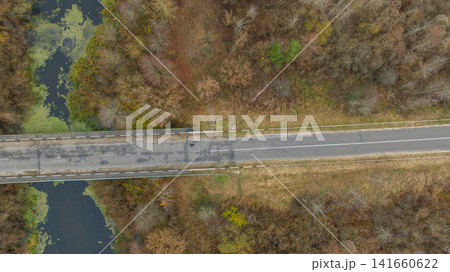 Aerial road and bridge over marshy river in rural Belarus Aerial road and bridge over marshy river in rural Belarus 141660622