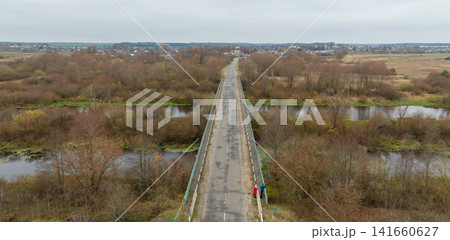 Aerial view of bridge across marshy river plain toward Belarus town Aerial view of bridge across marshy river plain toward Belarus town 141660627