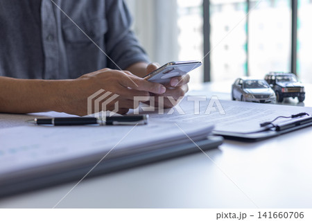 Client Reviewing Vehicle Finance Documents and Car Loan Policy. Client Reviewing Vehicle Finance Documents and Car Loan Policy. 141660706