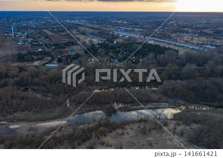 Aerial sunset over Warsaw wetlands, streams, and suburban townhouses 141661421