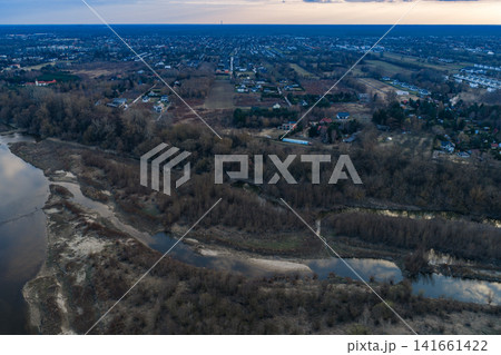 Aerial dusk view of river, wetlands, and Warsaw suburban outskirts Aerial dusk view of river, wetlands, and Warsaw suburban outskirts 141661422