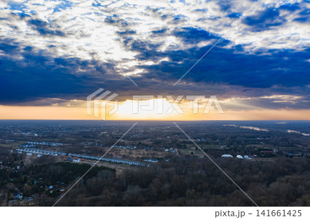 Aerial suburban outskirts near Warsaw at sunset with storm clouds 141661425