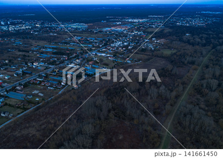 Aerial dusk view of Warsaw suburb meeting dense forest in Poland 141661450