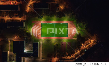 Aerial View of Illuminated Sports Field at Night in Urban Area 141661594