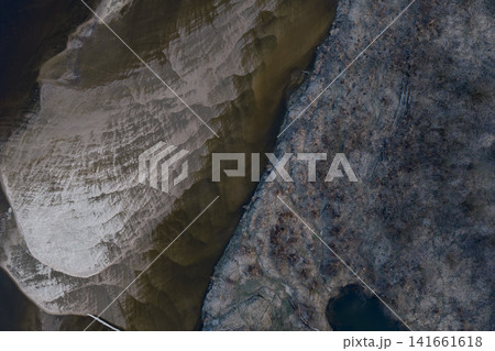 Aerial winter riverside near Warsaw with eroded pale cliffs and pond Aerial winter riverside near Warsaw with eroded pale cliffs and pond 141661618