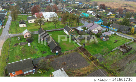 Aerial view of Belarus village with barns, cottages, and plots 141661730