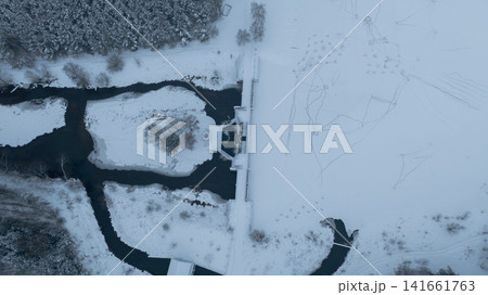 Aerial dam and sluice divide river and reservoir in Belarus winter Aerial dam and sluice divide river and reservoir in Belarus winter 141661763