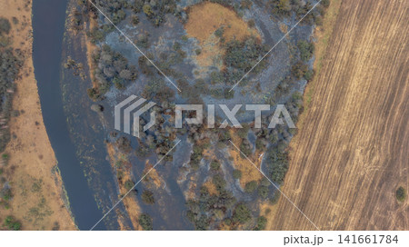 Aerial Belarusian floodplain river and harvested field in winter Aerial Belarusian floodplain river and harvested field in winter 141661784