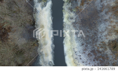 Aerial river corridor between thawing ice in Belarus winter Aerial river corridor between thawing ice in Belarus winter 141661789
