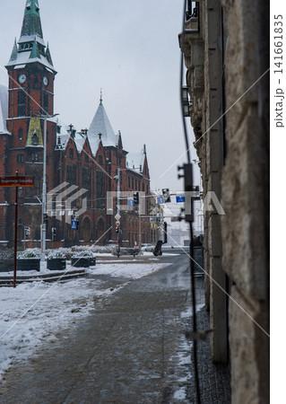 Winter street in Wroclaw with Neo Gothic clock tower and tram wires Winter street in Wroclaw with Neo Gothic clock tower and tram wires 141661835