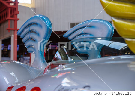 Decorative wing shaped elements are featured on a custom race car displayed indoors. The image showcases creative automotive styling and collector vehicle craftsmanship. Decorative wing shaped elements are featured on a custom race car displayed indoors. The image showcases creative automotive styling and collector vehicle craftsmanship. 141662120