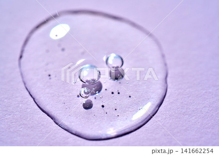 Serum drop with bubbles on purple background Serum drop with bubbles on purple background 141662254