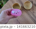 Hand Holding Pink Dumpling Shaped Stress Relief Toy 141663210