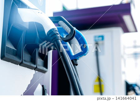 Electric car charging station for charge EV battery. Plug for vehicle with electric engine. EV charger. Clean energy. Charging point at car parking lot. Alternative energy. Future transport technology Electric car charging station for charge EV battery. Plug for vehicle with electric engine. EV charger. Clean energy. Charging point at car parking lot. Alternative energy. Future transport technology 141664041