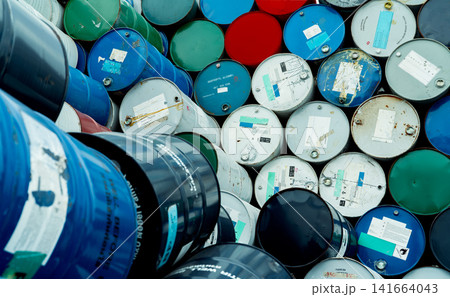 Old chemical barrels. Blue, red, and green chemical drum. Steel tank. Hazard chemical barrel with flammable liquid warning label. Industrial waste. Isopropyl alcohol and aluminized orgonosol barrels. Old chemical barrels. Blue, red, and green chemical drum. Steel tank. Hazard chemical barrel with flammable liquid warning label. Industrial waste. Isopropyl alcohol and aluminized orgonosol barrels. 141664043