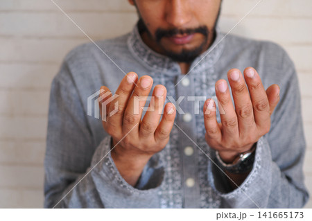 Hands raised in prayer during a quiet moment Hands raised in prayer during a quiet moment 141665173