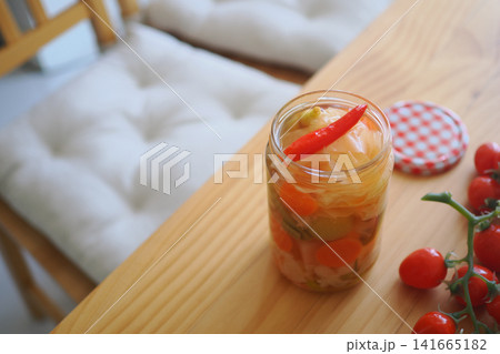 Jar of pickled vegetables with cherry tomatoes on table Jar of pickled vegetables with cherry tomatoes on table 141665182