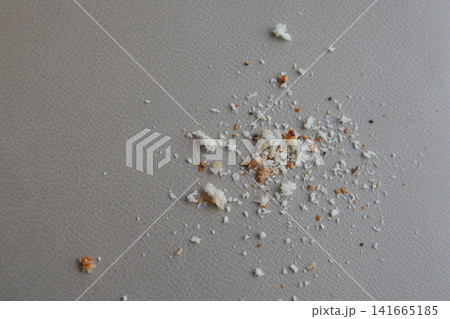 Crumbs scattered on a grey surface in a dining area 141665185