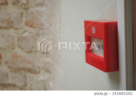 Fire alarm box on a wall in a building hallway Fire alarm box on a wall in a building hallway 141665202