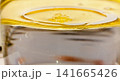 Golden yellow oil layer floating over water surface macro view pure natural vegetable olive oil liquid texture background photo image photography stock asset element 141665426