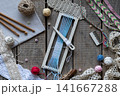 Flat lay weaving and macrame workspace with loom shuttle threads crochet hooks comb lace and craft accessories on rustic wooden table background 141667288