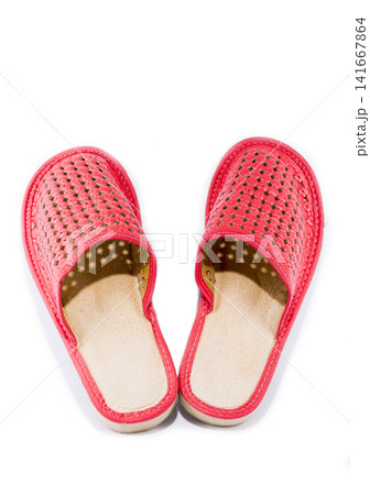 Red women's slippers on a white background Red women's slippers on a white background 141667864
