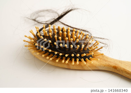 Asian woman have problem with long hair loss attach to comb brush. 141668340