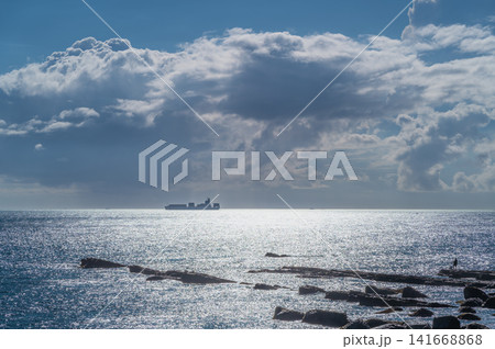 Cargo Ship on the Horizon in Taiwan Cargo Ship on the Horizon in Taiwan 141668868