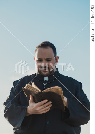 Monk Flipping The Pages Of The Bible Outdoor Monk Flipping The Pages Of The Bible Outdoor 141669593