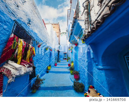 Colorful fabrics hanging in blue alley Colorful fabrics hanging in blue alley 141669708