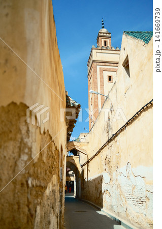 White minaret beside old urban walls White minaret beside old urban walls 141669739