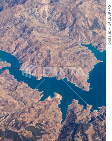 Aerial View of a Blue Reservoir in Arid Mountains 141669745