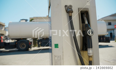 Diesel fuel pump hanging from the gas station Diesel fuel pump hanging from the gas station 141669802