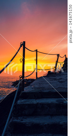 Stairways in rock over sea at sunset Stairways in rock over sea at sunset 141675150