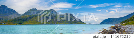 Fjord in rainy weather. Rocky beach in evening, White sand on the beach. Beautiful nature of Norway. Lofoten islands Fjord in rainy weather. Rocky beach in evening, White sand on the beach. Beautiful nature of Norway. Lofoten islands 141675239