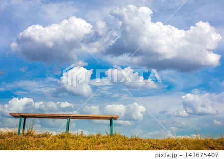 A bench against a beautiful sky. View from below 141675407