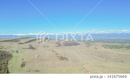 High angle aerial view of modern wind turbines farm on dry mountain hill for green renewable energy generation in Gori Georgia Caucasus landscape stock photo High angle aerial view of modern wind turbines farm on dry mountain hill for green renewable energy generation in Gori Georgia Caucasus landscape stock photo 141675669