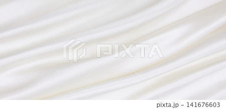 Smooth elegant white silk or satin luxury cloth texture as wedding background. Luxurious background design Smooth elegant white silk or satin luxury cloth texture as wedding background. Luxurious background design 141676603