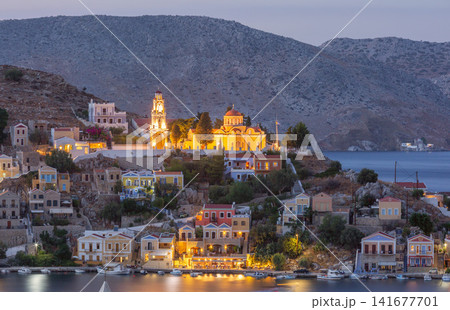 Illuminated Orthodox Church Above Symi Harbor at Blue Hour on Symi Island Greece Illuminated Orthodox Church Above Symi Harbor at Blue Hour on Symi Island Greece 141677701