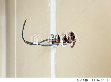 Electrical wiring installation inside unfinished drywall wall Electrical wiring installation inside unfinished drywall wall 141678384