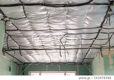 House renovation showing ceiling wiring and insulated roof structure House renovation showing ceiling wiring and insulated roof structure 141678388