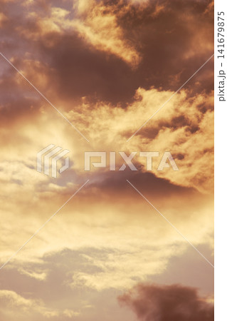 Dramatic cloudy sunset sky with warm golden light background texture Dramatic cloudy sunset sky with warm golden light background texture 141679875