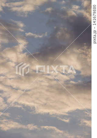 Dramatic dark storm clouds catching golden warm sunlight during sunset Dramatic dark storm clouds catching golden warm sunlight during sunset 141679880